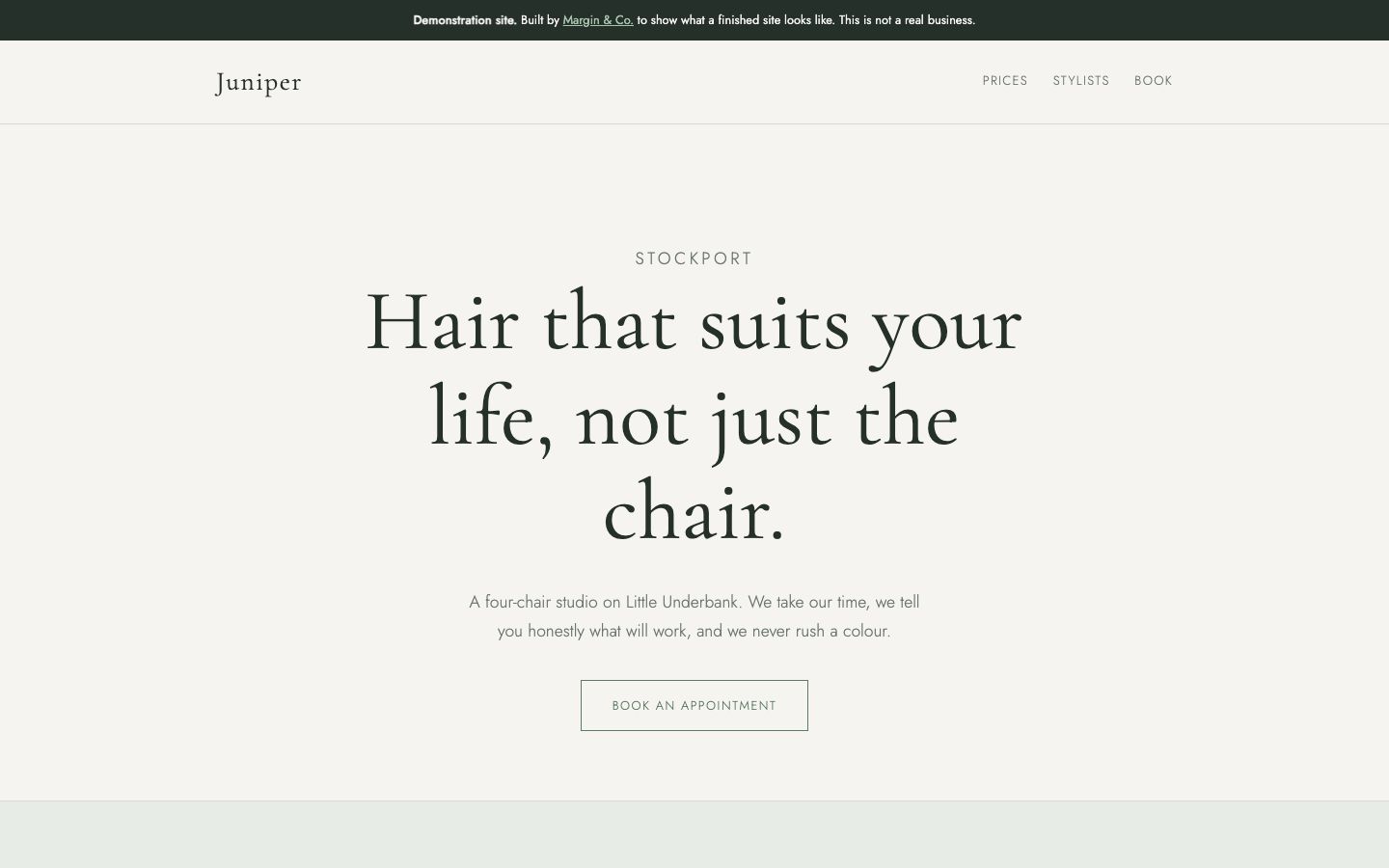 Juniper Hair Studio homepage: pale sage page with a centred serif headline reading Hair that suits your life, not just the chair, and an outlined booking button.